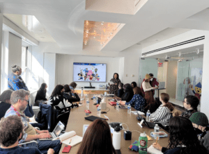 Sarah Wallendjack presents to a group of RespectAbility Lab Fellows in 9 Story Media Groups' board room in New York City.