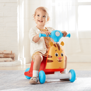 Little girl riding the Daniel Tiger Hop on Bike